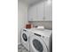 Well-appointed laundry room with washer, dryer, and ample cabinets at 9233 E Sector Dr, Mesa, AZ 85212