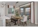 Bright dining room with a farmhouse table and access to the backyard at 9233 E Sector Dr, Mesa, AZ 85212