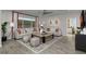 Spacious living room with large sectional sofa and wood-look tile floors at 9233 E Sector Dr, Mesa, AZ 85212