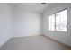 Well-lit bedroom featuring neutral carpet and large window at 3812 W Lodge Dr, Laveen, AZ 85339