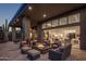 Covered patio with fire pit and comfortable seating, overlooking the living room at 10284 E Running Deer Trl, Scottsdale, AZ 85262