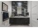 Elegant powder room with dark vanity and textured wall tiles at 10284 E Running Deer Trl, Scottsdale, AZ 85262