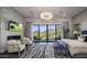 Luxurious main bedroom with a fireplace, large windows, and access to a patio at 10284 E Running Deer Trl, Scottsdale, AZ 85262
