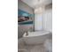 Relaxing bathroom featuring a freestanding tub and large window at 10284 E Running Deer Trl, Scottsdale, AZ 85262