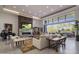 Open living space with a fireplace, large windows, and patio access at 10284 E Running Deer Trl, Scottsdale, AZ 85262