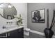 Stylish bathroom with a white sink, dark vanity, and textured walls at 10284 E Running Deer Trl, Scottsdale, AZ 85262