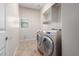 Laundry room with washer, dryer, and built-in shelving at 4120 E Donato Dr, Gilbert, AZ 85298