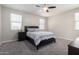 Bright bedroom with carpeted floor and ceiling fan at 1952 N 212Th Ln, Buckeye, AZ 85396