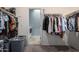 Large walk-in closet with custom shelving and hanging rods at 1952 N 212Th Ln, Buckeye, AZ 85396