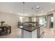 Modern kitchen with large island, white cabinets, and granite countertops at 1952 N 212Th Ln, Buckeye, AZ 85396