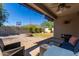 Relaxing backyard patio with fire pit, seating area, and mountain views at 1952 N 212Th Ln, Buckeye, AZ 85396