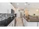 Modern kitchen with island, white cabinets, and granite countertops at 1952 N 212Th Ln, Buckeye, AZ 85396