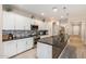 Modern kitchen with white cabinets, granite countertops and island at 1952 N 212Th Ln, Buckeye, AZ 85396