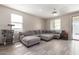 Spacious living room with L-shaped sectional sofa and tile floors at 1952 N 212Th Ln, Buckeye, AZ 85396