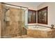 Bathroom with a large walk-in shower, soaking tub, and tiled floors at 28217 N 139Th St, Scottsdale, AZ 85262