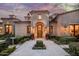 Elegant home entrance with a herringbone walkway and lush landscaping at 20567 N 112Th St, Scottsdale, AZ 85255
