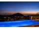 Expansive pool at night with city views and blue lighting at 20567 N 112Th St, Scottsdale, AZ 85255