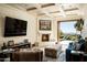 Cozy Gathering room with fireplace, large TV, and access to a patio at 20567 N 112Th St, Scottsdale, AZ 85255