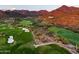 Aerial view of green golf course with mountain backdrop at 20567 N 112Th St, Scottsdale, AZ 85255