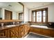 Elegant bathroom with double vanity, soaking tub, and stained-glass window at 20567 N 112Th St, Scottsdale, AZ 85255