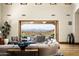 Spacious living room with large windows, mountain views, and hardwood floors at 20567 N 112Th St, Scottsdale, AZ 85255