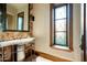 Elegant powder room with marble vanity and stained glass window at 20567 N 112Th St, Scottsdale, AZ 85255