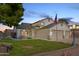Two-story house with three-car garage and manicured lawn at dusk at 7752 W Mary Jane Ln, Peoria, AZ 85382