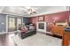 Living room with a cozy fireplace, hardwood floors, and built-in shelving at 7752 W Mary Jane Ln, Peoria, AZ 85382