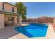 Large backyard with refreshing pool, covered patio, and seating at 7752 W Mary Jane Ln, Peoria, AZ 85382