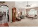Spacious living room with hardwood floors, large windows, and a view into the kitchen at 7752 W Mary Jane Ln, Peoria, AZ 85382