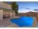 Evening view of the backyard pool, patio and home at 7752 W Mary Jane Ln, Peoria, AZ 85382