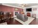 Living room with dark hardwood floors, a fireplace, and plenty of seating at 7752 W Mary Jane Ln, Peoria, AZ 85382
