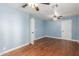 Bedroom with hardwood floors, two ceiling fans, and blue walls at 7752 W Mary Jane Ln, Peoria, AZ 85382