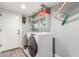 Functional laundry room with washer, dryer, and shelving at 7752 W Mary Jane Ln, Peoria, AZ 85382