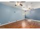 Well-lit bedroom featuring hardwood floors and dual ceiling fans at 7752 W Mary Jane Ln, Peoria, AZ 85382
