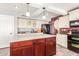 Updated kitchen with granite countertops, stainless steel appliances, and an eat-in island at 7752 W Mary Jane Ln, Peoria, AZ 85382
