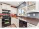 Kitchen features a built in microwave, gas range, and modern sink with a window view at 7752 W Mary Jane Ln, Peoria, AZ 85382