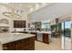 Open kitchen with island seating and views to Gathering room and patio at 9719 E Madera Dr, Scottsdale, AZ 85262