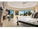 Luxurious main bedroom with fireplace, large windows, and stunning views at 9719 E Madera Dr, Scottsdale, AZ 85262