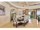 Elegant dining room featuring a large wooden table and access to a patio with scenic views at 9719 E Madera Dr, Scottsdale, AZ 85262