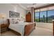 Charming bedroom with mountain views and a wooden sleigh bed at 9719 E Madera Dr, Scottsdale, AZ 85262
