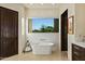 Spa-like bathroom with freestanding tub and large window at 9719 E Madera Dr, Scottsdale, AZ 85262