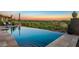 Relaxing infinity pool with mountain views and lounge chairs at 9719 E Madera Dr, Scottsdale, AZ 85262