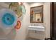 Modern powder room with floating vanity and decorative wall art at 9719 E Madera Dr, Scottsdale, AZ 85262