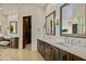 Double vanity bathroom with large mirrors and walk-in closet at 9719 E Madera Dr, Scottsdale, AZ 85262