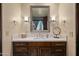 Vanity with a marble countertop and an ornate mirror at 9719 E Madera Dr, Scottsdale, AZ 85262