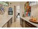 Modern wet bar with white countertops, dark cabinetry, and wine storage at 9719 E Madera Dr, Scottsdale, AZ 85262