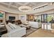 Open living room with high ceilings, white sofas and a large chandelier at 9719 E Madera Dr, Scottsdale, AZ 85262