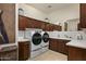 Laundry room with washer, dryer, and ample storage at 9719 E Madera Dr, Scottsdale, AZ 85262