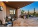 Outdoor kitchen with built-in grill and seating area at 9719 E Madera Dr, Scottsdale, AZ 85262